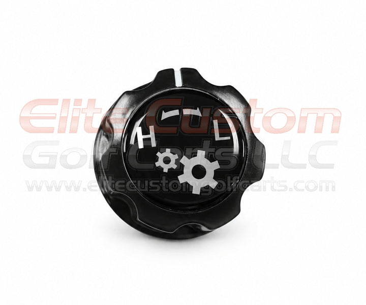 A black plastic gear shift knob with white markings and a gear icon, shown on a white background with a watermark.