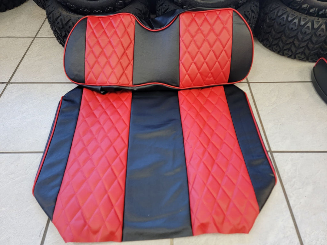 A set of custom diamond-stitched black and red seat covers for a golf cart.